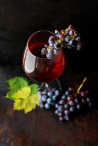 Glass of red wine and grapes.