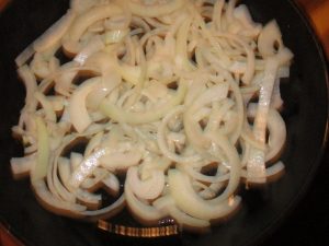 skillet of sliced white onions