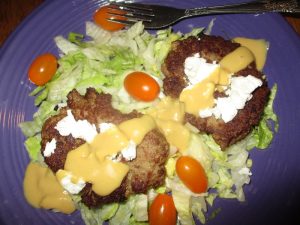 goat cheese turkey burger on a salad