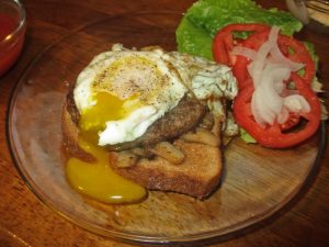 open faced runny egg on a burger