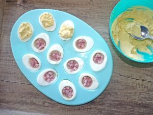 assembling ham into eggs