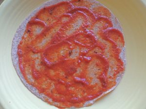 tortilla with pizza sauce for Folded Pizza Quesadilla